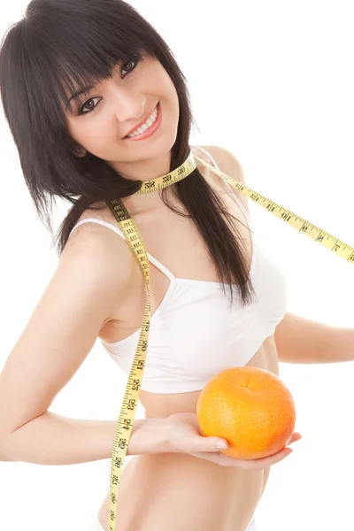 Cute woman with orange and measure tape — Stock Photo, Image