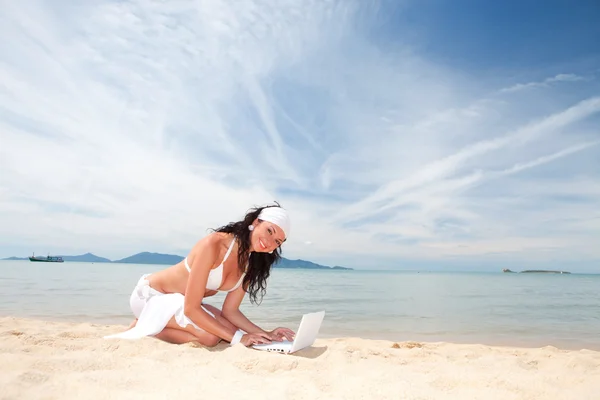 stock image Cute woman with white laptop on the summer beach