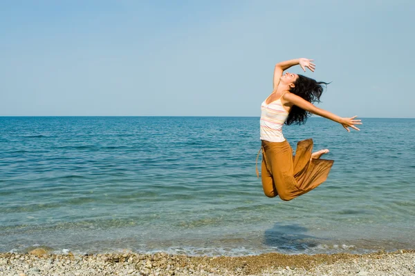 Feliz joven mujer está bailando en la playa —  Fotos de Stock