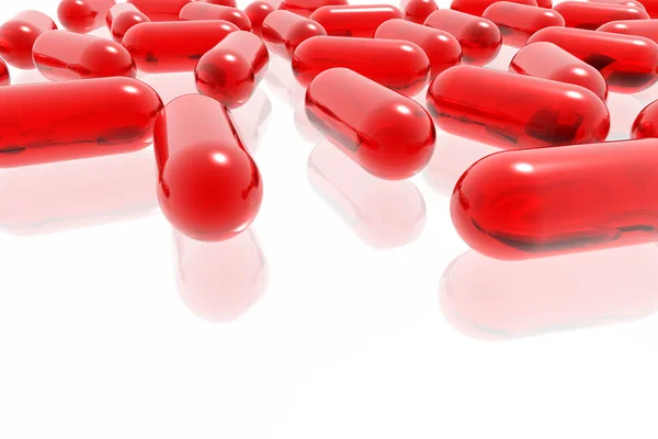 Červené pilulky na bílém pozadí — Stock fotografie