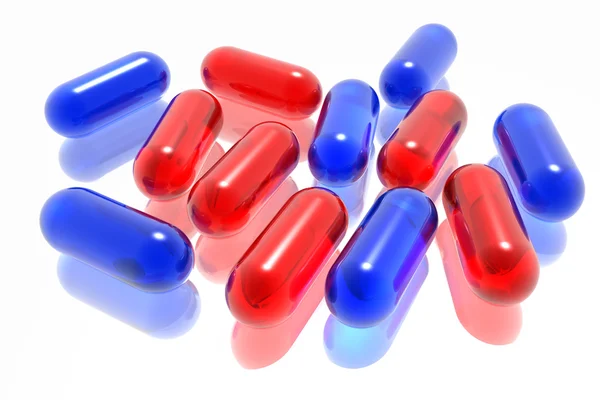 Czerwone i niebieskie tabletki na białym tle — Zdjęcie stockowe