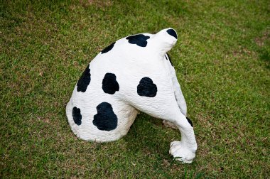 The Sculpture of dalmatian submerged soil on green grass backgr clipart