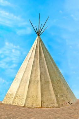 The Classic native Indian tee-pee on blue sky background clipart