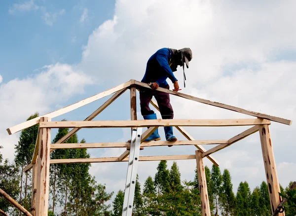 Les ouvriers grimpent sur la structure en bois — Photo