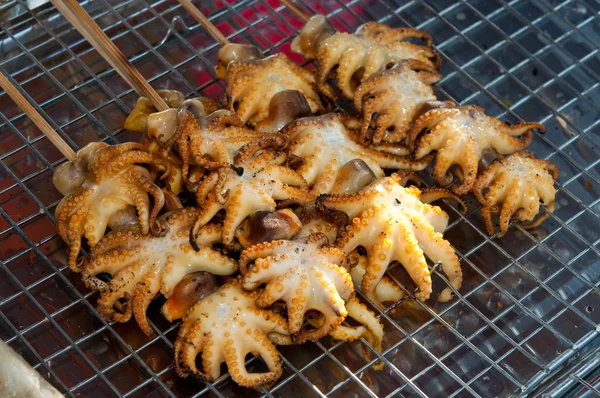 The Seafood barbecue of grilled squid on charcoal oven