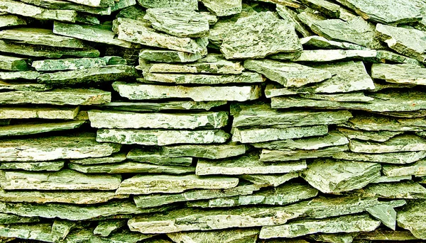 A textura de fundo da parede de pedra ardósia — Fotografia de Stock