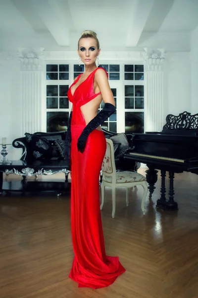 Elegant blonde in a red dress — Stock Photo, Image
