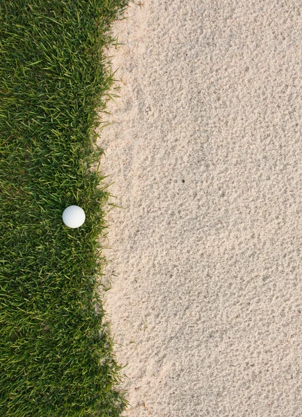 Golf ball and sand bunker — Stock Photo, Image
