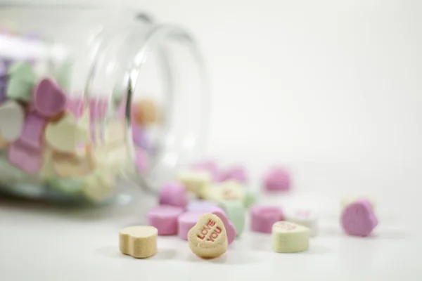 Spilled jar of valentine hearts — Stock Photo, Image