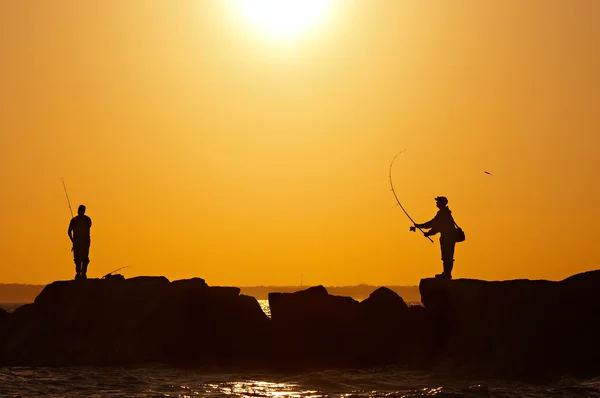 Fishermens at sunset Stock Image