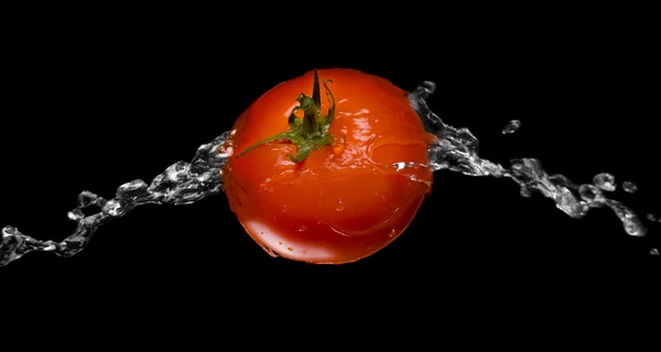 stock image Red tomato splash macro isolated over black background