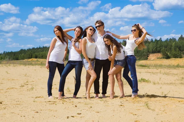 Group of six friends all in blue jeans and white — Stock Photo, Image