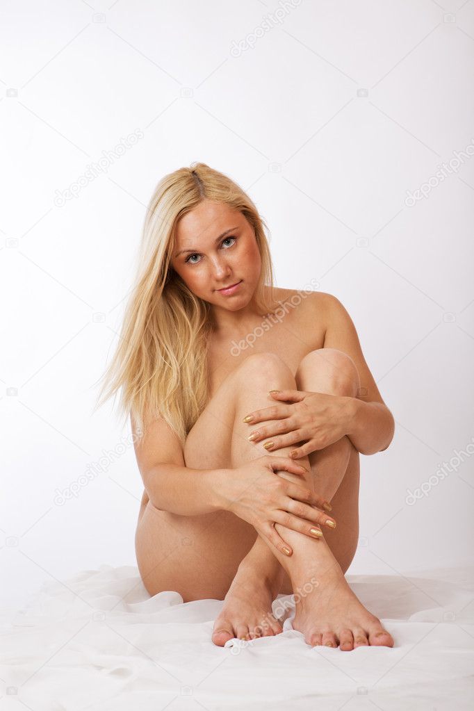 Cute young blond girl naked sitting
