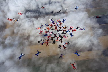 Group of skydivers in formation clipart