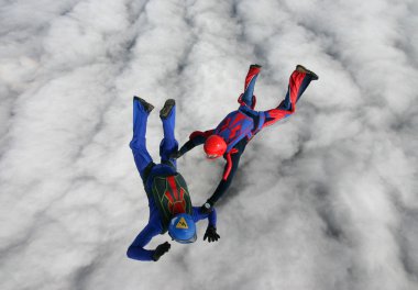 Skydivers over clouds clipart