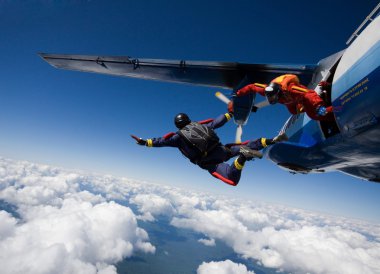 Two skydivers jumping from airplane