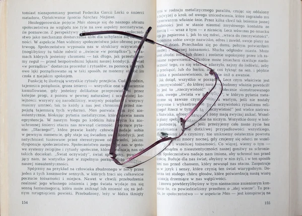 stock image Glasses on a book