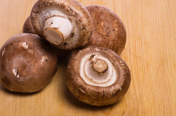 Portobella mushrooms on a cutting board