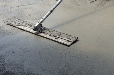 Finishing a concrete floor clipart
