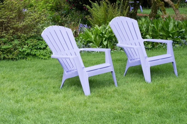 Purple chairs in a green lawn