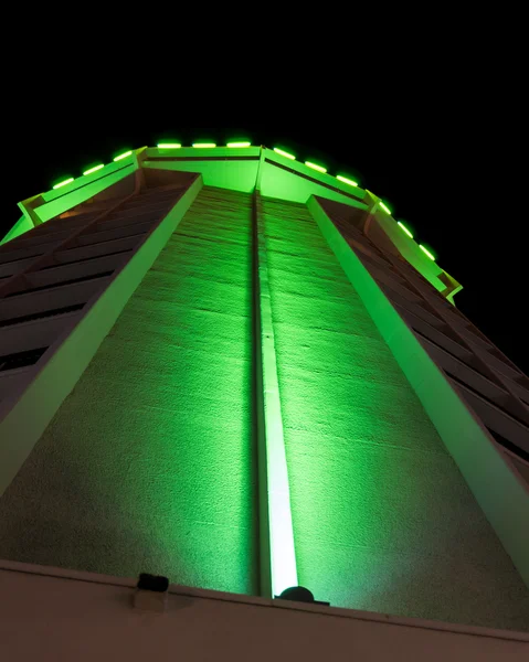stock image Apartment building lit by green lights