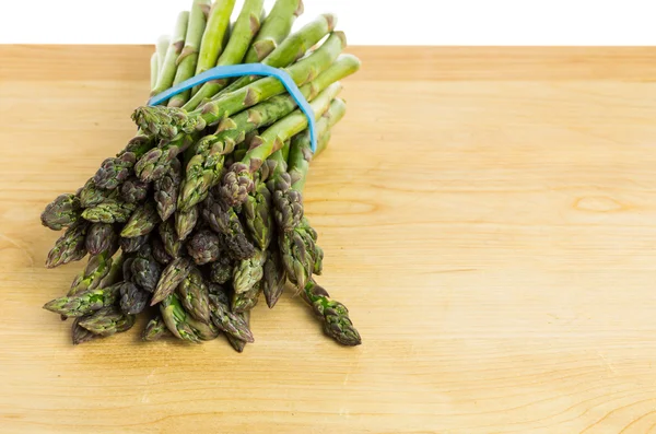 Bunch of Asparagus spears with blue band — Stock Photo, Image
