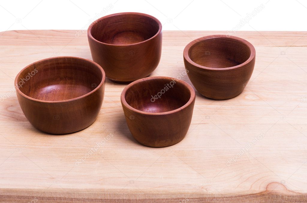 Four wooden bowls on cutting board
