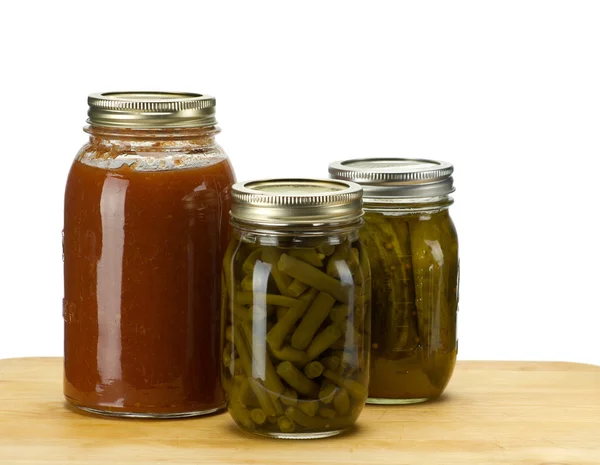 Three jars of homemade canned produce — Stock Photo, Image