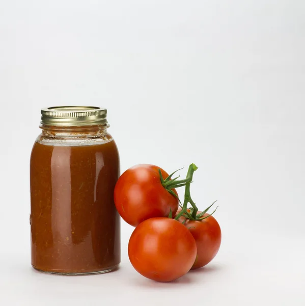 Tomatoes and tomato sauce on white — Stock Photo, Image