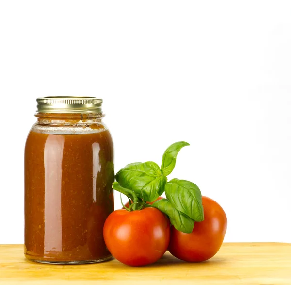Tomatoe sauce tomatoes and basil — Stock Photo, Image