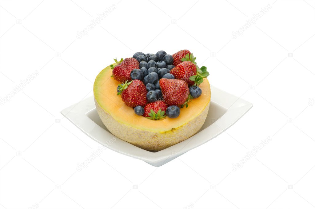 Fruit desert of berries and cantaloupe in white bowl