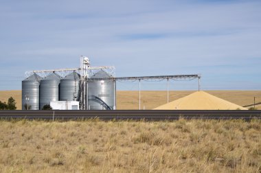 Grain storage silos with conveyor clipart