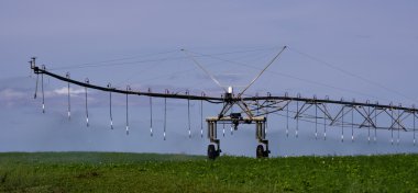 Pivot irrigation system in operation supplying water clipart