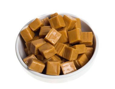 Sweet caramels in white bowl clipart