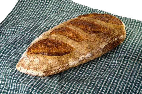 Fresh baked peasant batard on green cloth — Stock Photo, Image