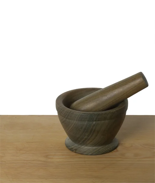 Wooden mortar and pestle sitting on a table — Stock Photo, Image