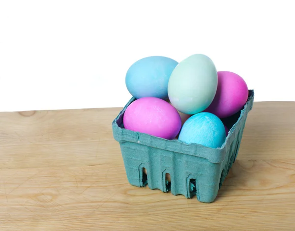Small green basket of colored eggs — Stock Photo, Image