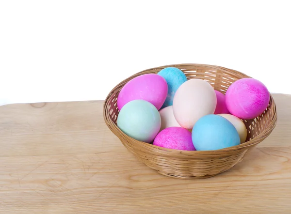 Wicker basket of colored eggs — Stock Photo, Image