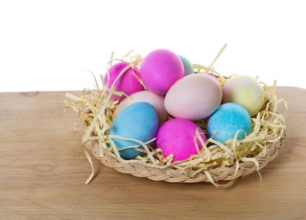 Wicker tray of colored eggs — Stock Photo, Image