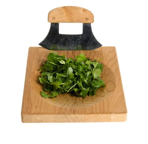 Chopping board and knife with diced cilentro — Stock Photo, Image