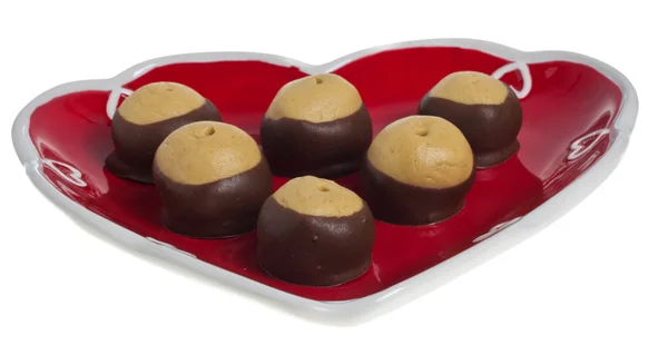 Heart shaped plate six buckeye cookies — Stock Photo, Image