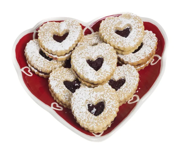Heart shaped plate covered with heart shaped cookies — Stock Photo, Image