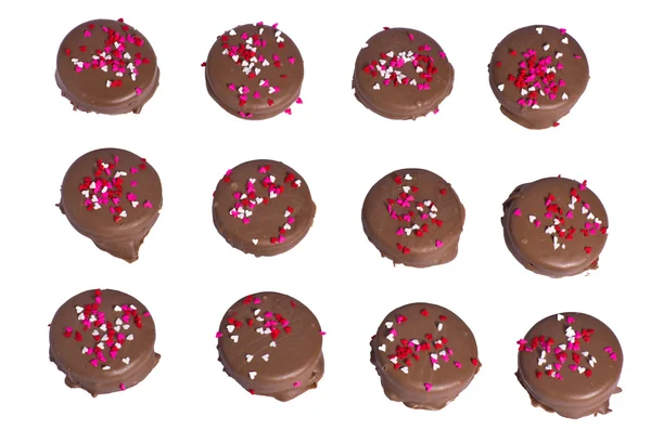 Twelve chocolate cookies with heart sprinkles — Stock Photo, Image