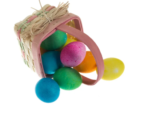 Square Easter basket spilling dyed eggs — Stock Photo, Image