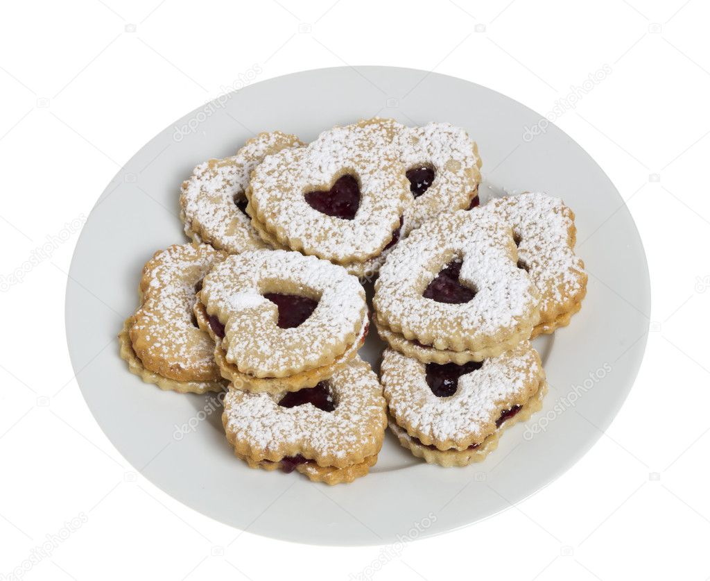 Plate of heart shaped cookies isolated on white