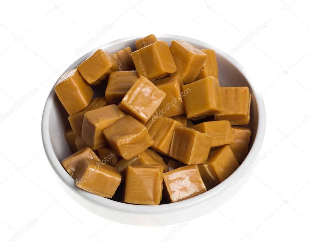 Sweet caramels in white bowl