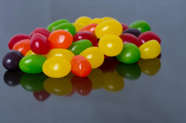 Assorted Jelly Beans on glossy black — Stock Photo, Image