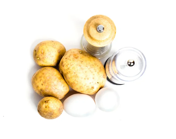 New potatoes, eggs and salt and pepper shakers — Stock Photo, Image