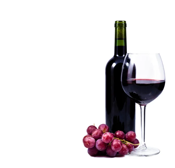 Wine glass with red wine, bottle of wine and grapes — Stock Photo, Image