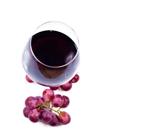 Wine glass with red wine and grapes — Stock Photo, Image